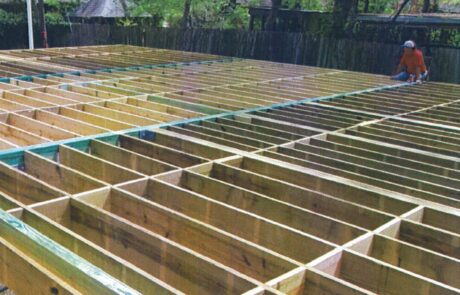 Treated Glulam Beams in an outdoor setting with trees