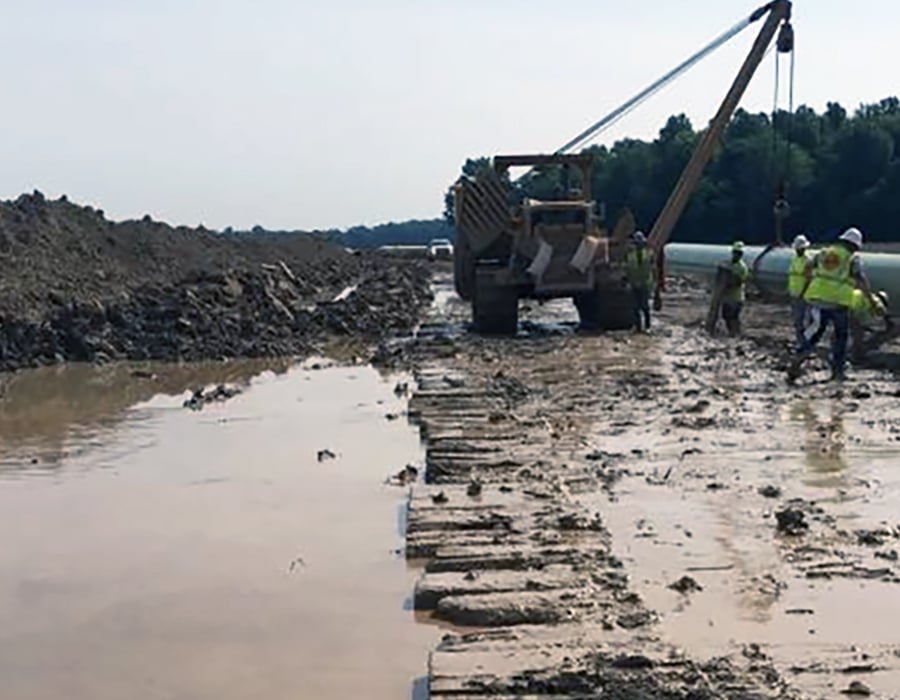 Construction work site with mat pipeline row laid out